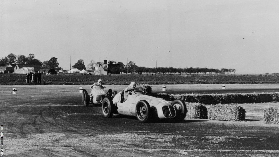 Action from the 1948 British Grand Prix, with drivers racing past hay bales serving as barriers