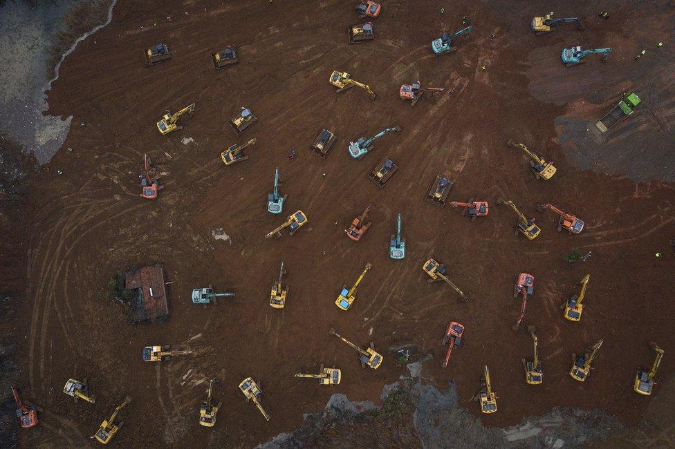 An aerial view of cranes and diggers building Huoshenshan Hospital