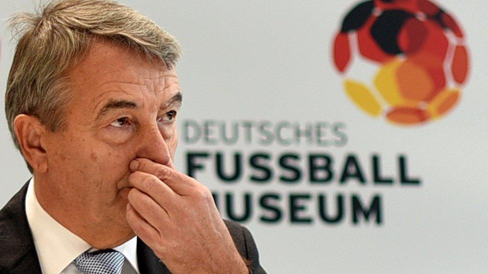 A photo taken in October 2015 shows Wolfgang Niersbach, President of the German Football Federation (DFB), standing behind the football of the 1954 final World Cup match during his visit at the new German Football Museum in Dortmund, western Germany