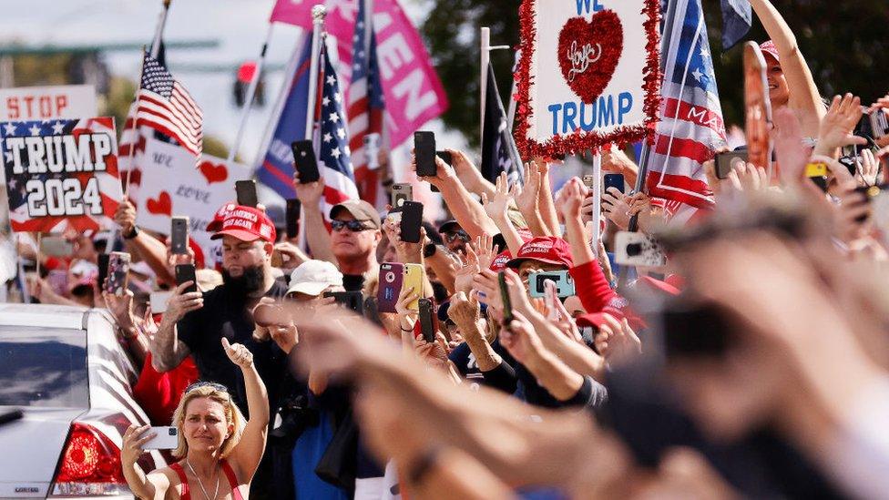 Supporters wave t Donald Trump as he returns to Florida along the route leading to his Mar-a-Lago estate on in West Palm Beach, Florida