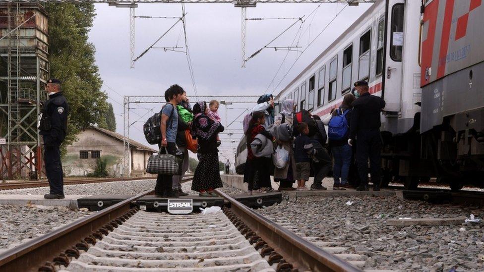 Migrants board a train leaving to Hungary at Tovarnik, Croatia