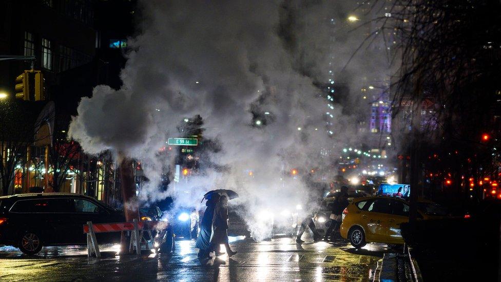 Smoke from a steam vent is photographed in New York city street