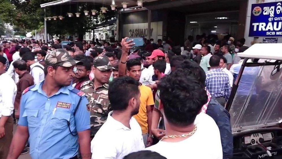 People outside a hospital in Cuttack, India