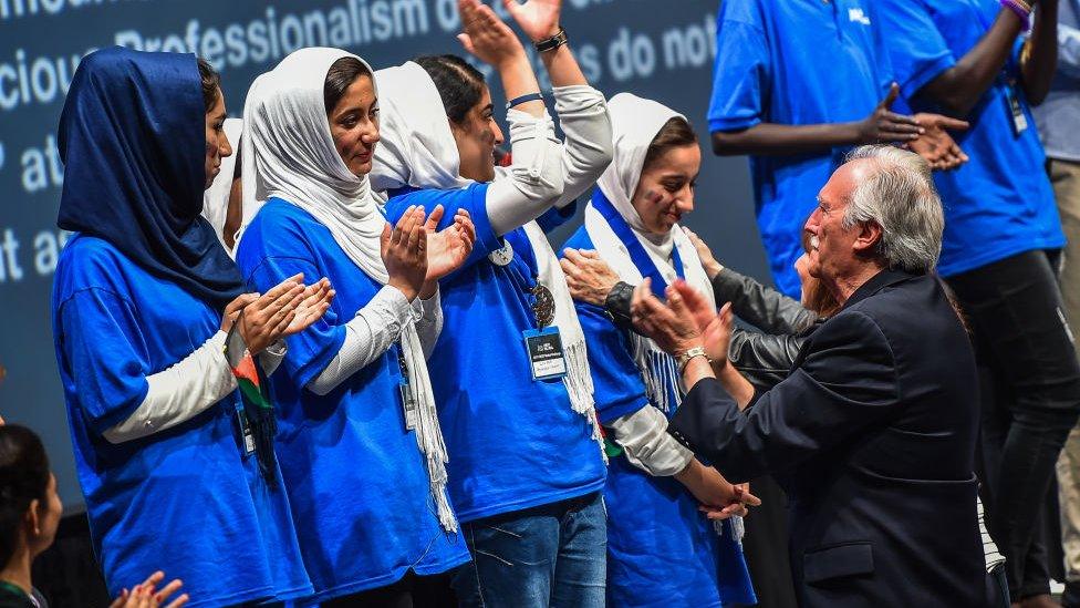 Team Afghanistan cheer after receiving silver for Rajaa Cherkaoui El Moursli Award for Courageous Achievement during the FIRST Global Challenge, international annual robotics game awards ceremony in 2017 in Washington DC