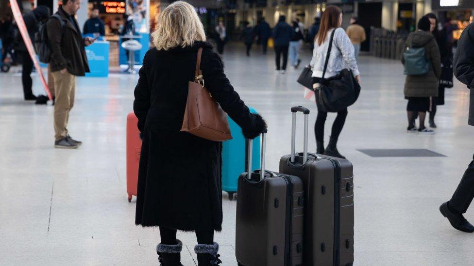 Woman at station with bags