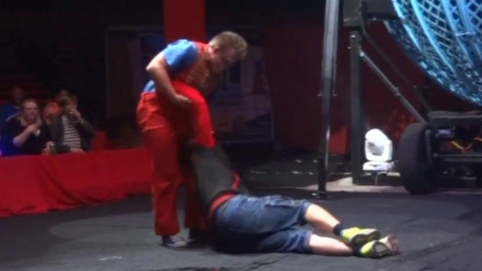 Ben Garnham lying on the floor of the circus