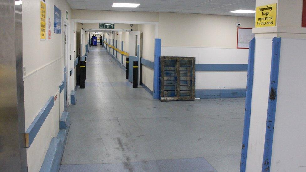 A view of one of the corridors with worn out floors