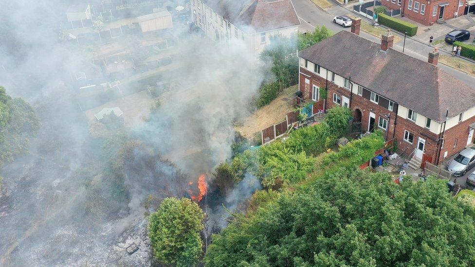 Gardens burning behind houses in Sheffield