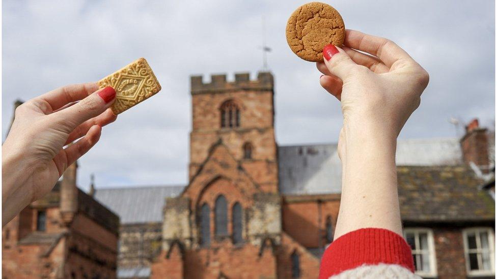 Hands holding biscuits in Carlisle