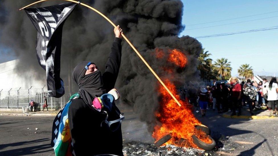 People take part in a protest against Chiles government