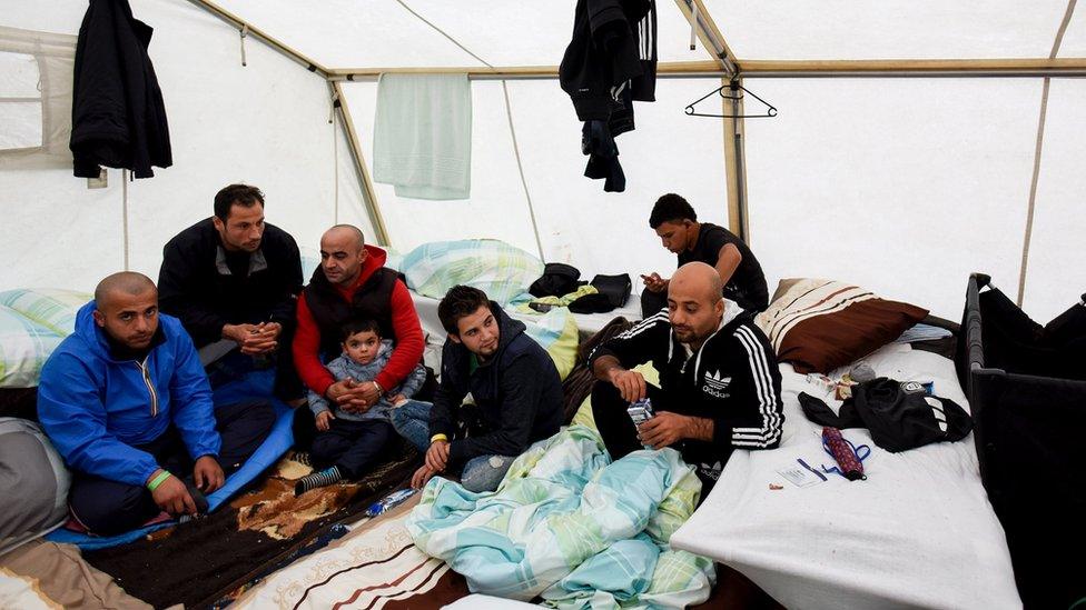 Migrants from Syria sit in their tent in a refugee camp in Celle, Lower Saxony, Germany (October 15, 2015)