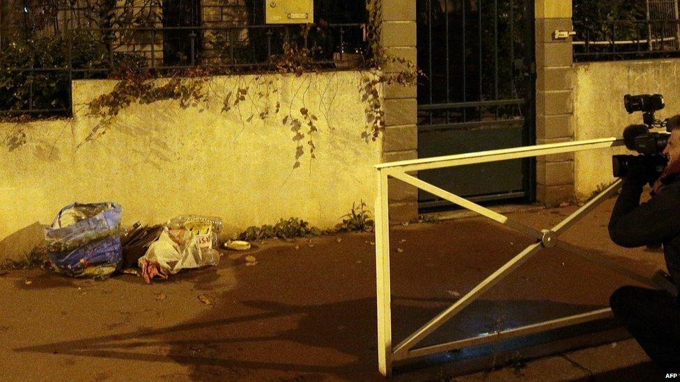 Trash is piled up on a street corner where what appears to be an explosives belt was found in Montrouge. Photo: 23 November 2015