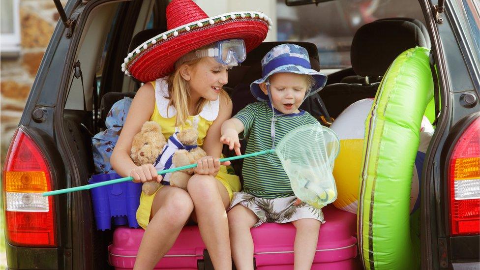 siblings-sitting-in-back-of-car.