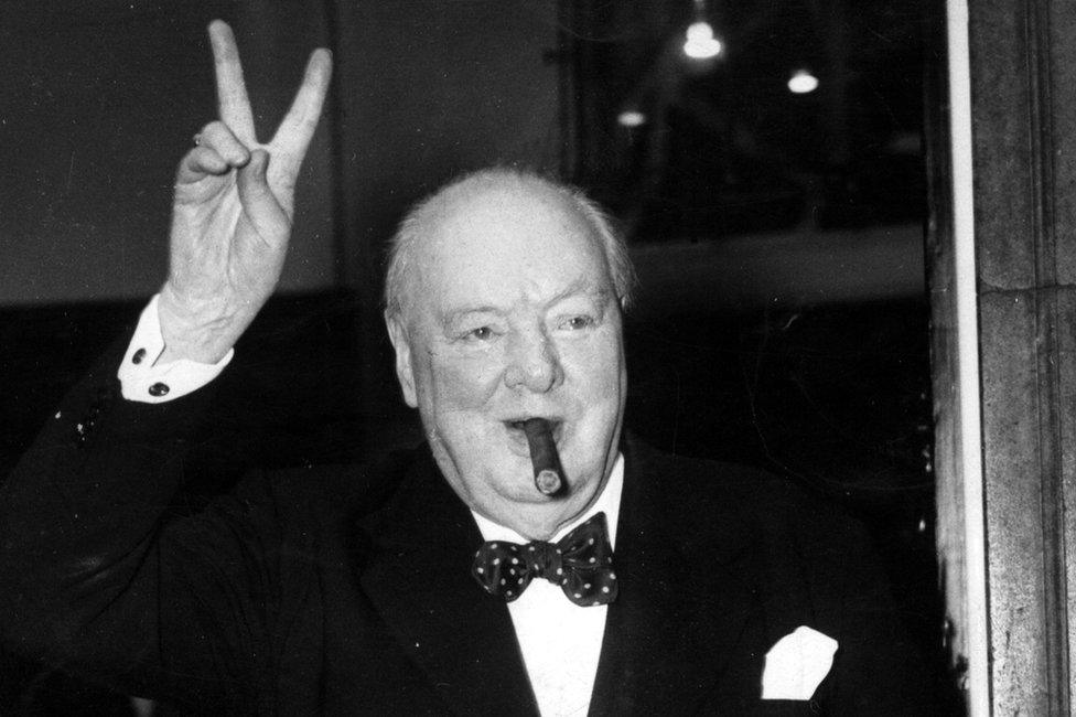 Winston Churchill gives his familiar and famous V for Victory sign after a lunchtime meeting, at 10 Downing Street