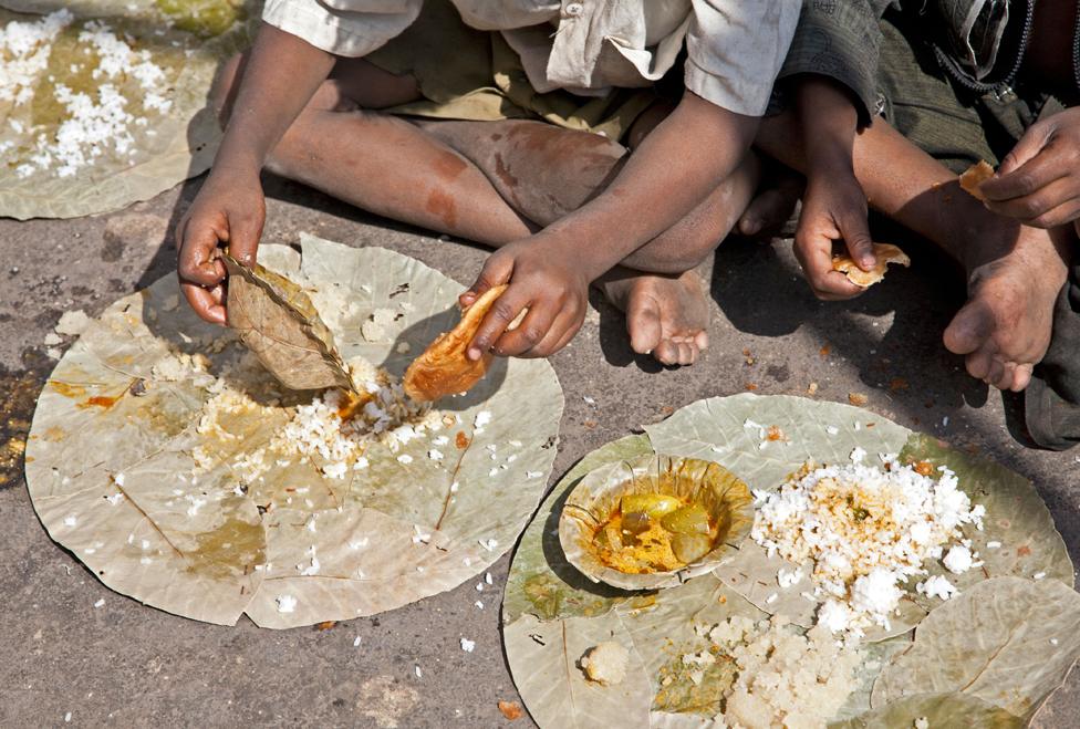 Boys eating a thali in Nasik, India