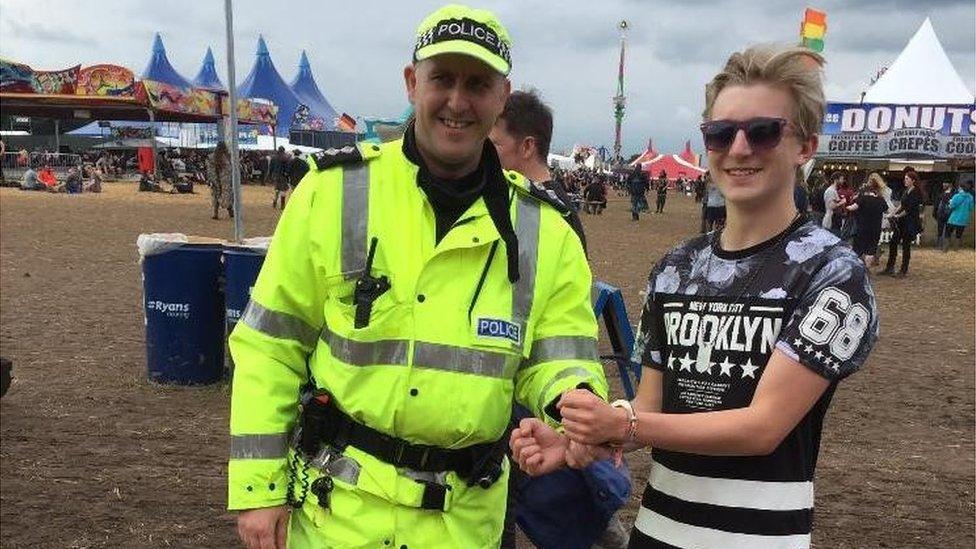 Armed officer pretending to arrest a fan