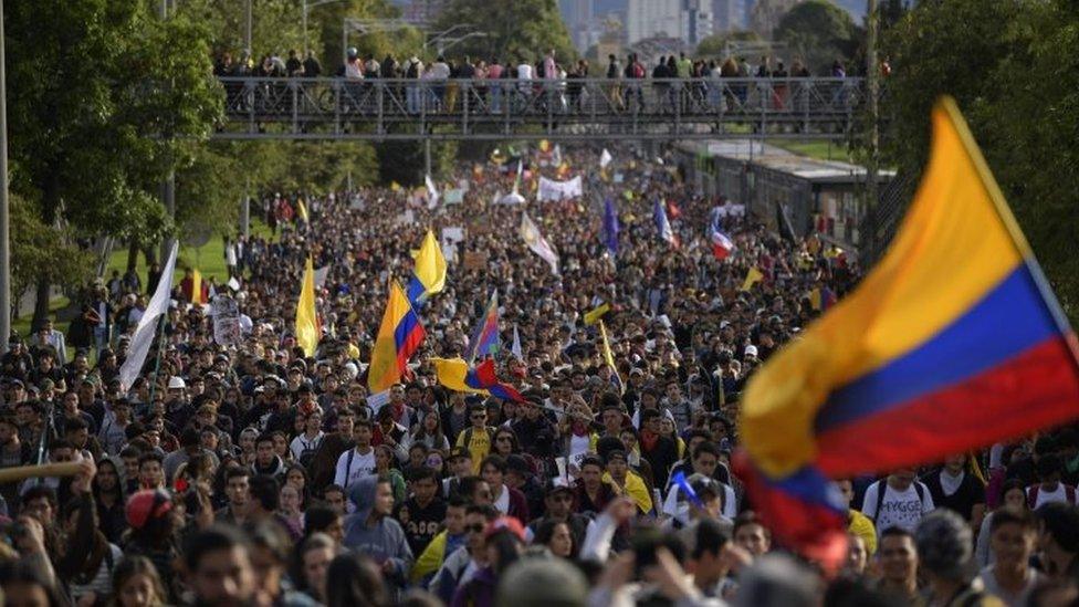 People march in an anti-government protest in Bogota on 27 November, 2019