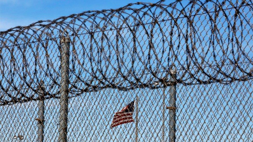 Barbed wire and an American flag at a prison in Louisiana