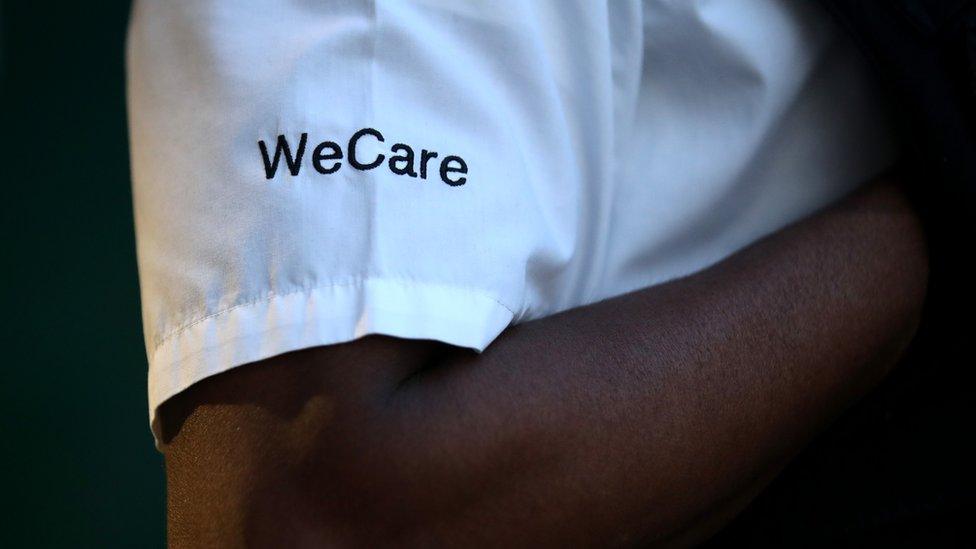 'We care' written on a white uniform of someone clapping