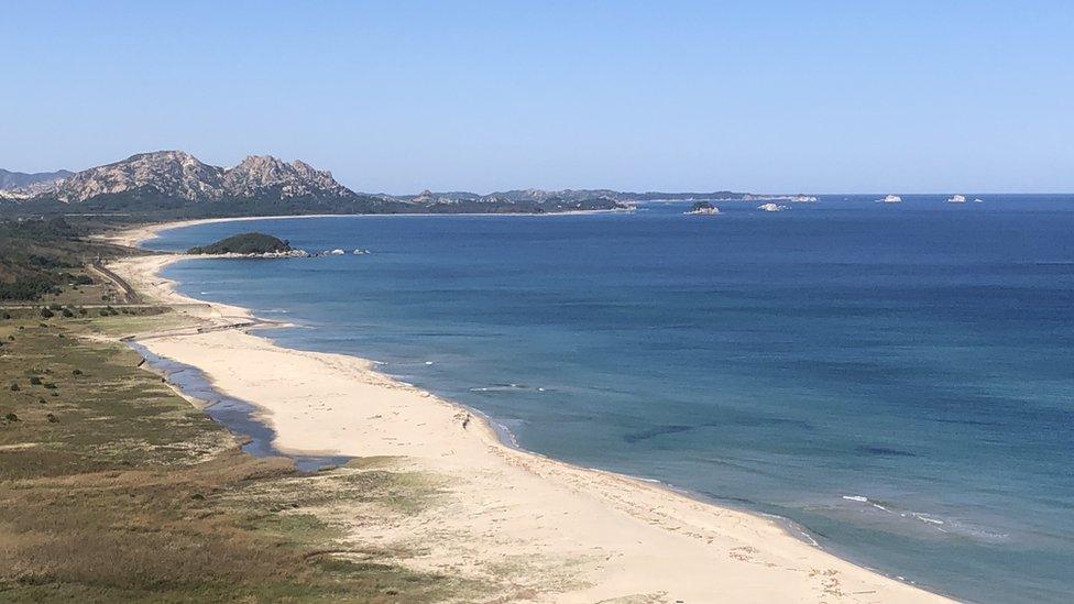 Large sandy beach looking north from the Geosong Observatory