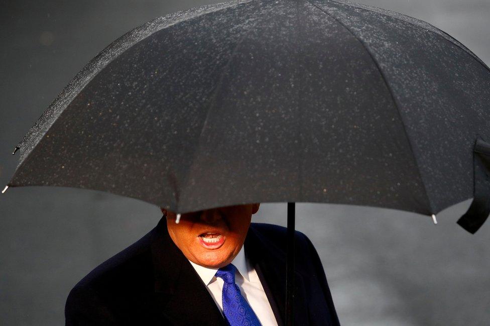 US President Donald Trump delivers remarks to the press at the South Lawn of the White House on a rainy day in Washington DC, before boarding Marine One, 2 December 2019.