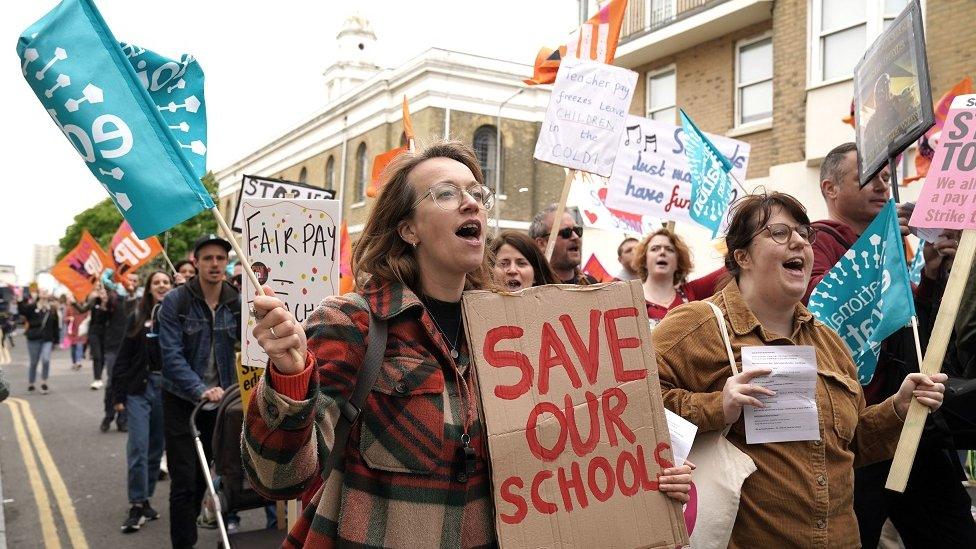 Teachers on strike holding placards