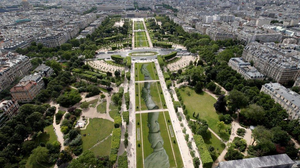 This aerial picture taken on June 13, 2019 shows a 600 meters long installation by French land artist SAYPE entitled "Beyong Walls"