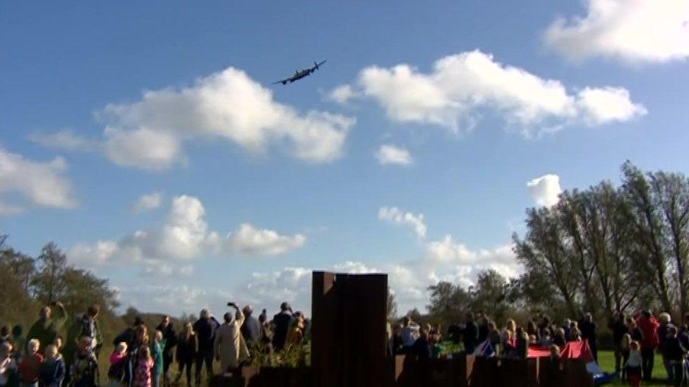 Lancaster bomber from the Battle of Britain Memorial Flight flying over the crash site