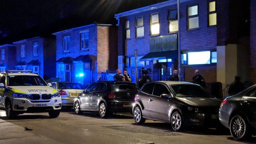 Police officers outside the Dar Ul Isra community centre in Cathays