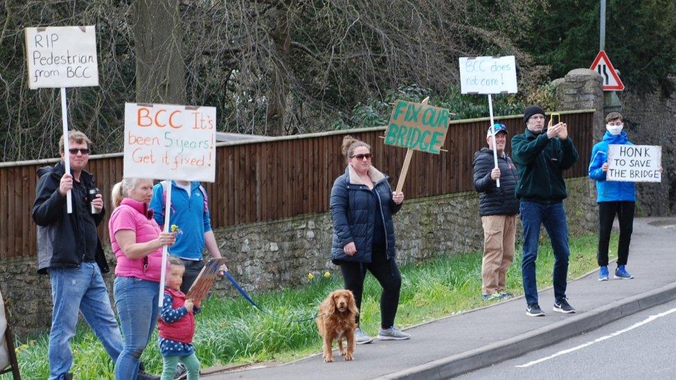 Campaigners hold signs saying 'save our bridge'