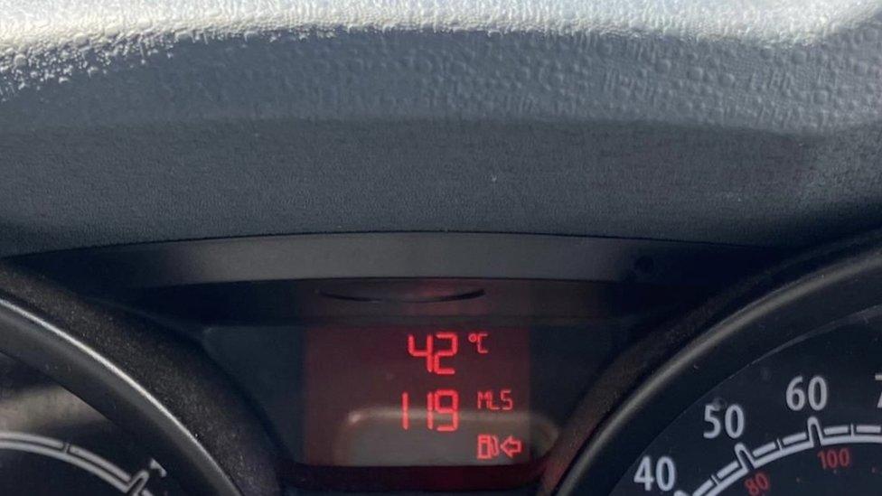 Car thermometer showing 42 degrees C