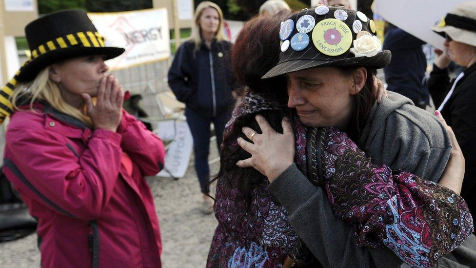 Protestors hug