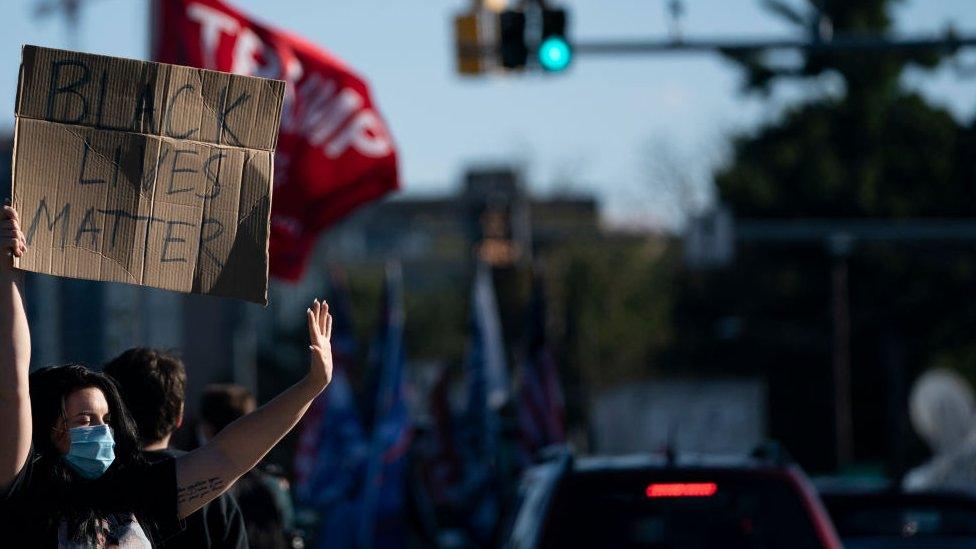 Black Lives Matter demonstrators counter-protest as supporters of U.S. President Donald Trump rally outside Walter Reed National Military Medical Center on October 3, 2020