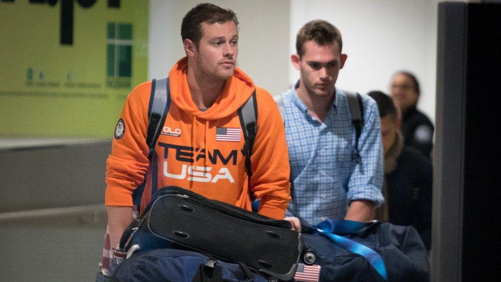 Jack Conger (L) and Gunnar Bentz are escorted through the International terminal at Miami International Airport upon their arrival to the United States from Rio de Janeiro, Brazil on August 19, 2016