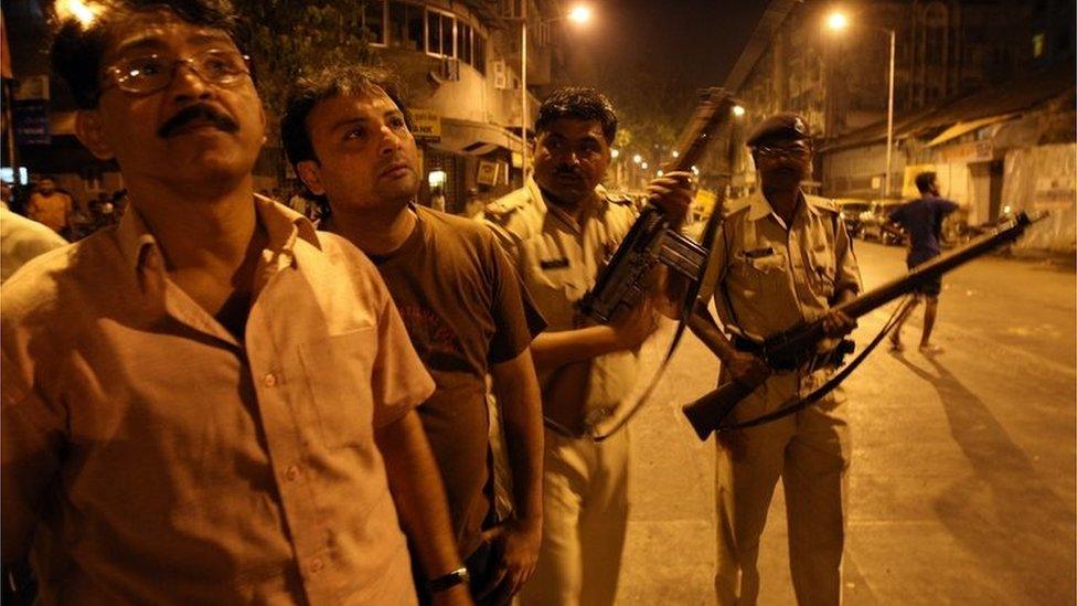 Indian policemen prepare to take position at the site of attack in the Colaba area of Mumbai on November 27, 2008.