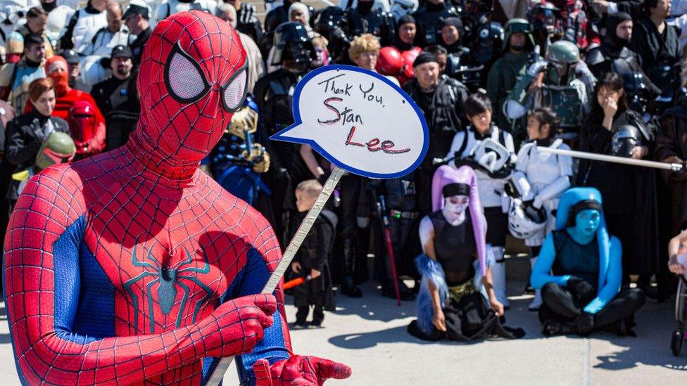 Spider-Man-costume-holding-sign-up.