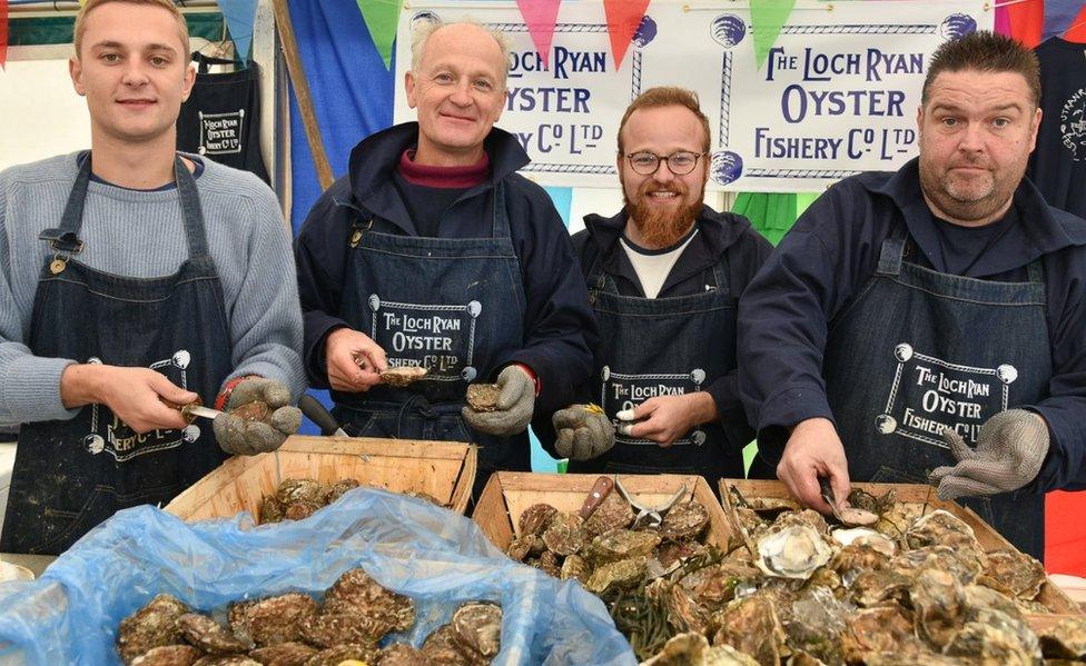 Men shelling oysters at Oyster Festival