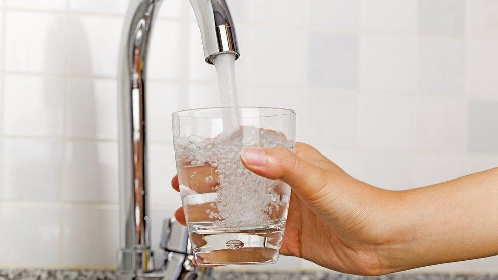 Glass being filled with water