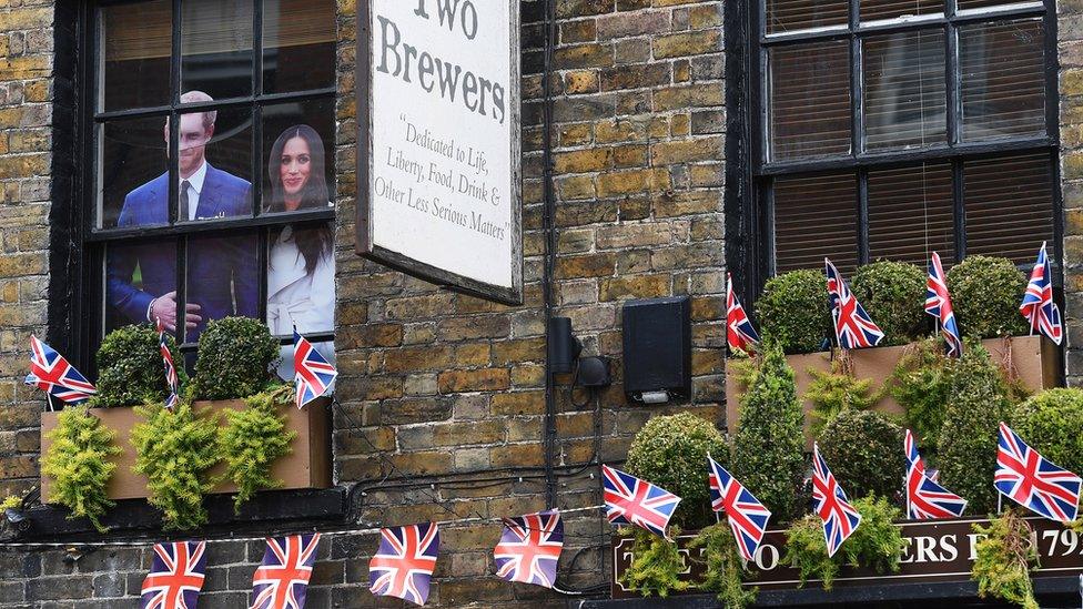 A cardboard cut out of Prince Harry and Meghan Markle stands in a pub window in Windsor