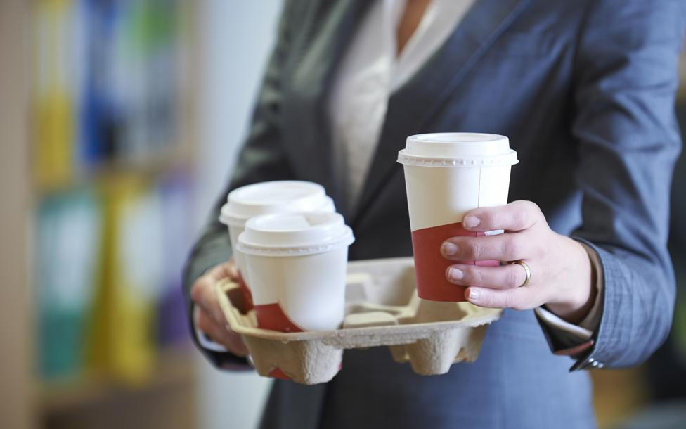 Woman holding plastic cups