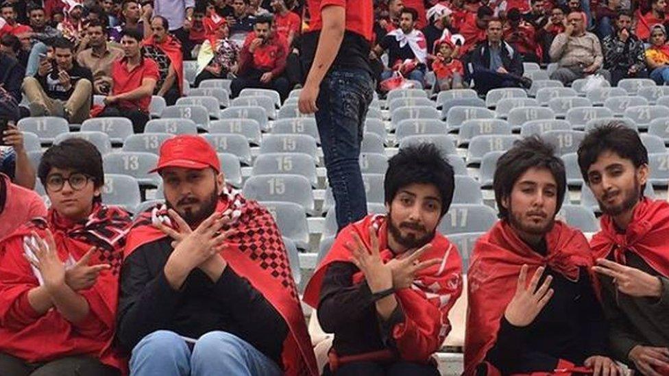 Women disguised as men at the football match