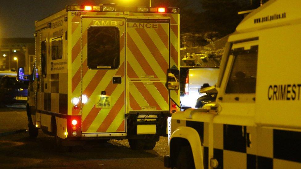 An ambulance and a police vehicle at the scene of the shooting