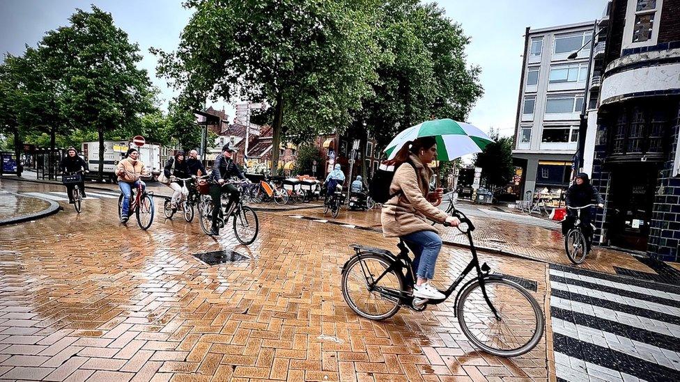 People cycling in the rain in the Netherlands