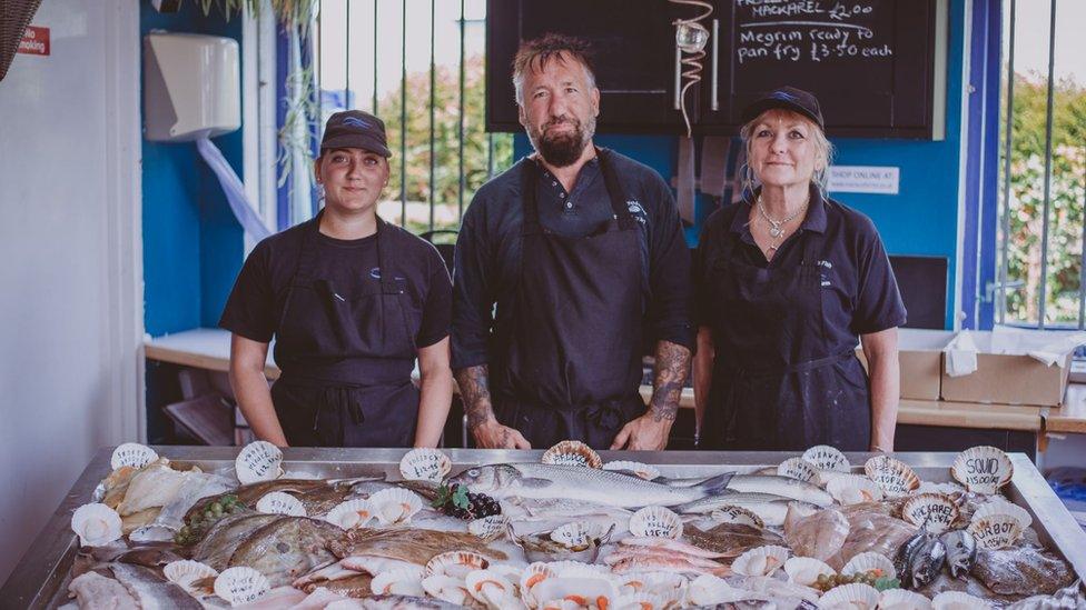 Fishmongers with fresh fish display