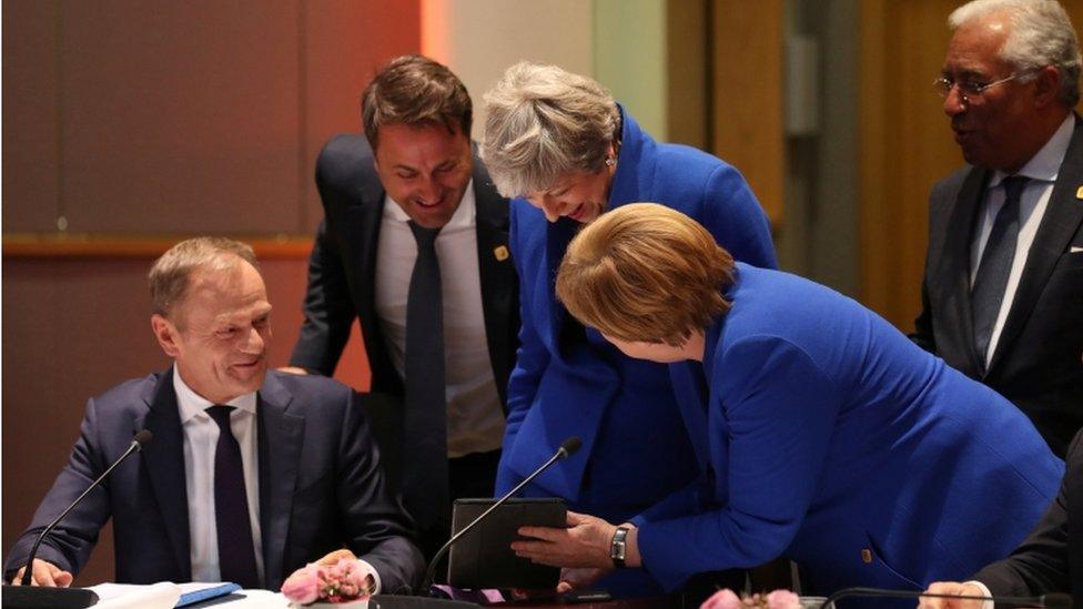 European Council President Donald Tusk, Luxembourg"s Prime Minister Xavier Bettel, Britain"s Prime Minister Theresa May, Germany"s Chancellor Angela Merkel and Portugal"s Prime Minister Antonio Costa look at a tablet