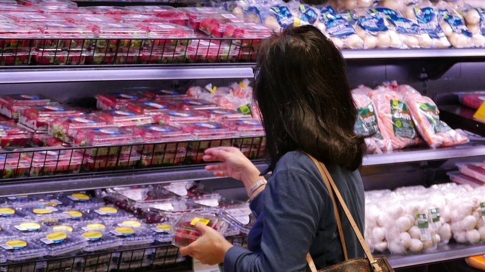 A shopper selects items inside a plastic bag-free Woolworths supermarket in Sydney, Australia, June 15, 2018.