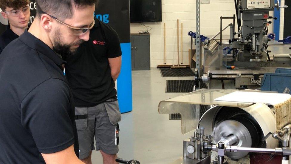 A student working on machinery