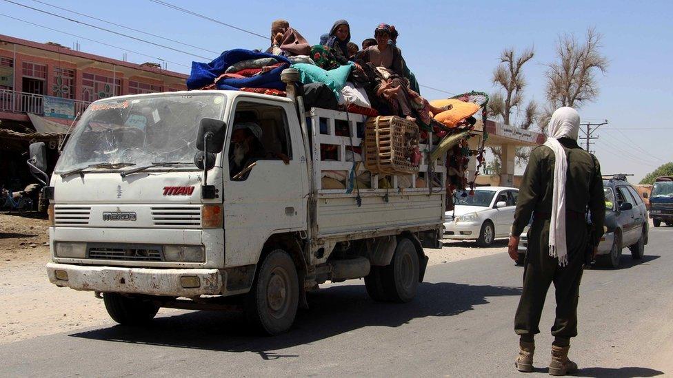 A family at a checkpoint in Helmand province, fleeing intense battles between government troops and the Taliban