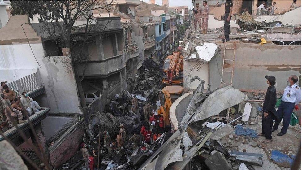 rescue workers search the wreckage