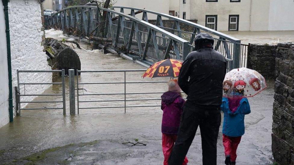 River rises to bridge with family watching on